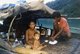 Thailand: A Chao Thalae 'Sea Gypsy' family preparing food aboard their boat, c. 1960
